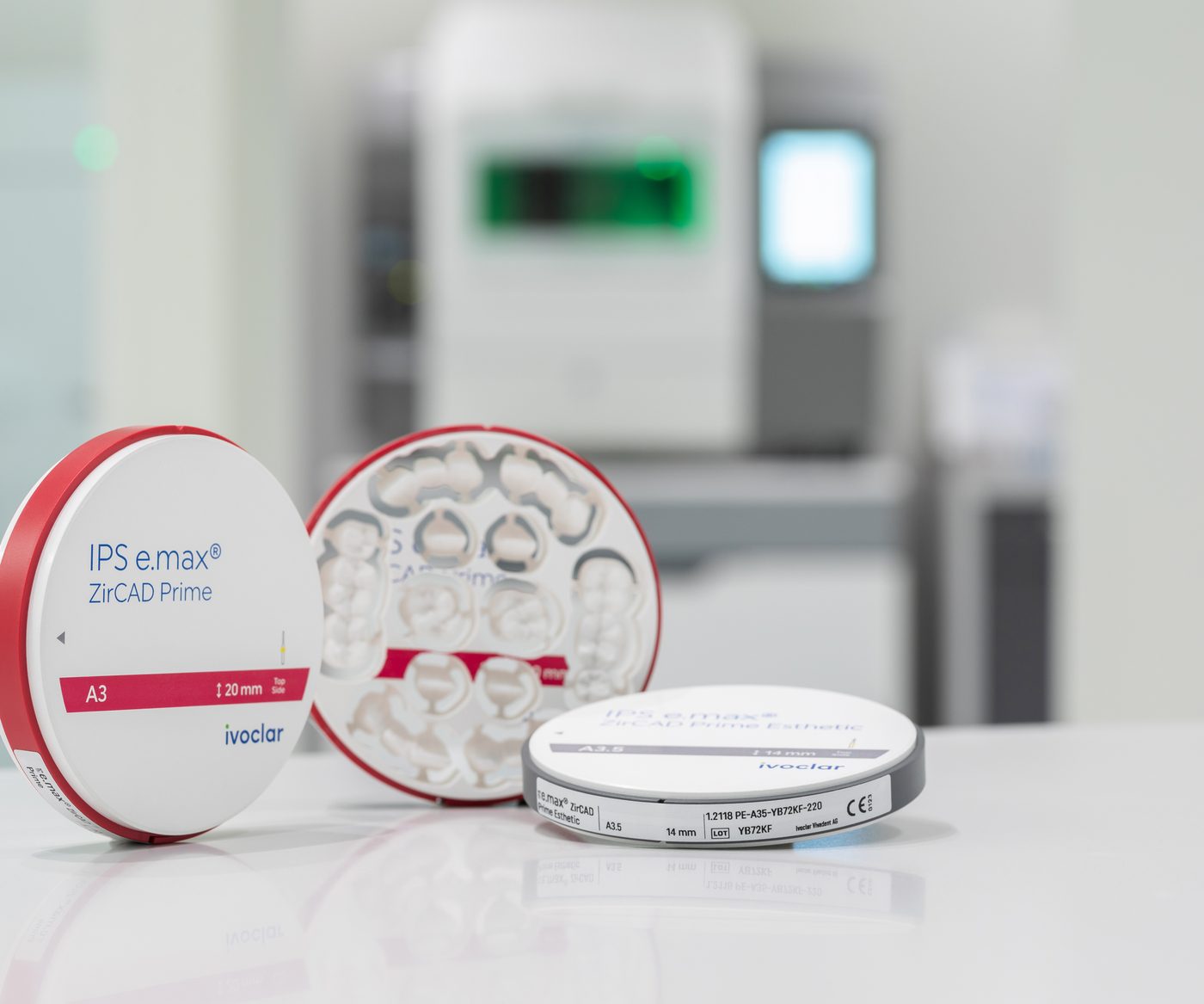 Zirconia discs on a bench in front of a milling unit